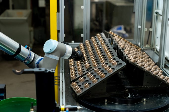 Automatisierung einer Produktionsanlage mittels Cobot mit einem Werkzeugmagazin für bis zu 100 Halbzeuge.